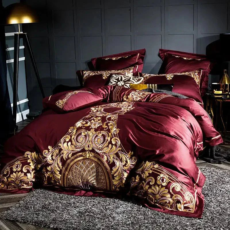 Royal-style Egyptian Cotton Sheets in rich red with ornate embroidery and multiple matching pillows.