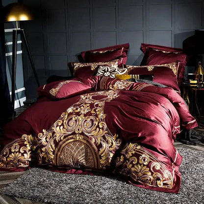 Royal-style Egyptian Cotton Sheets in rich red with ornate embroidery and multiple matching pillows.