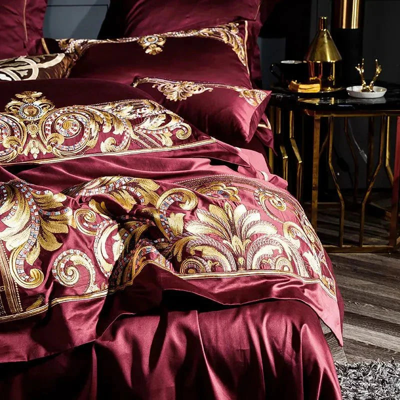 Close-up of golden embroidery on red Egyptian Cotton v highlighting its detailed craftsmanship.