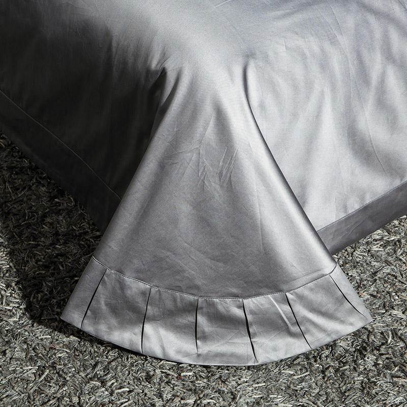 Pleated bed skirt in high-thread-count Egyptian Cotton Sheets, finished in silver grey.