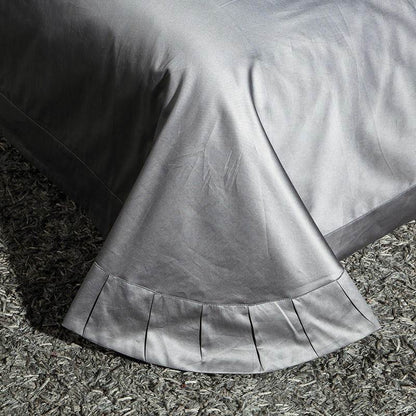 Pleated bed skirt in high-thread-count Egyptian Cotton Sheets, finished in silver grey.
