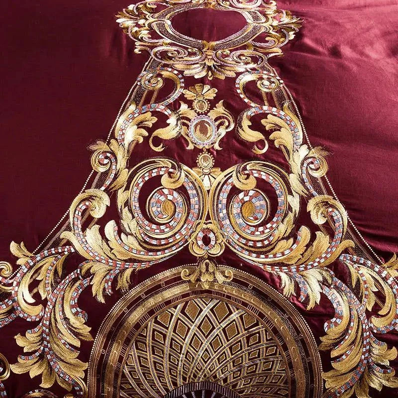 Red Egyptian Cotton Sheets pillow with baroque embroidery design, styled on a dark luxury bed.