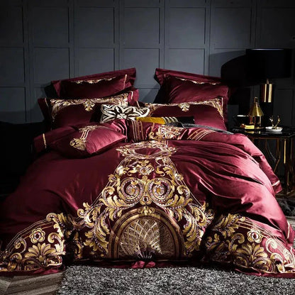 Luxurious red Egyptian Cotton Sheets set with golden embroidery displayed on a bed in a dark elegant room.